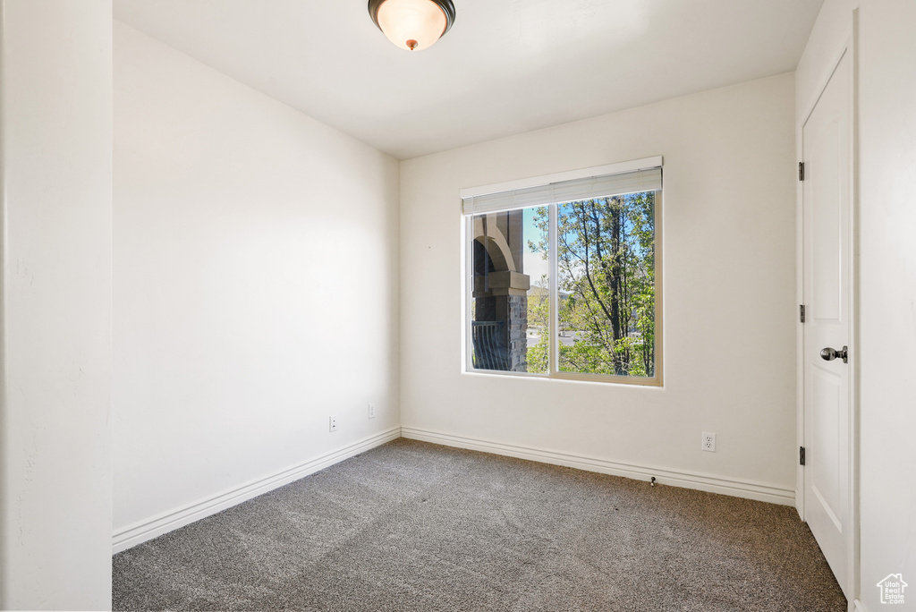 Unfurnished room with baseboards and carpet