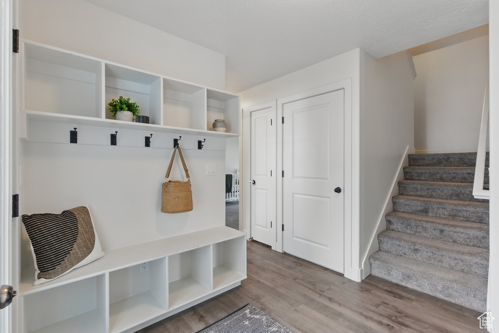 Mudroom with baseboards and wood finished floors