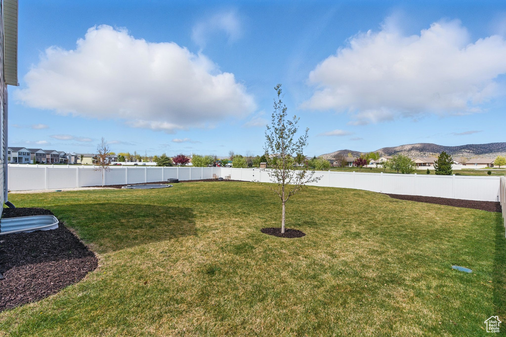 View of yard with a fenced backyard and a mountain view