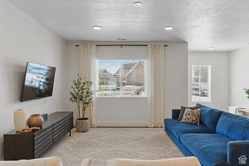 Living room with baseboards and a textured ceiling
