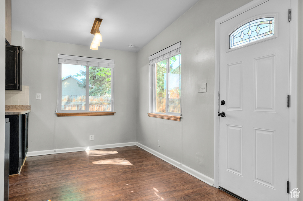 Entryway with dark wood-style flooring and baseboards