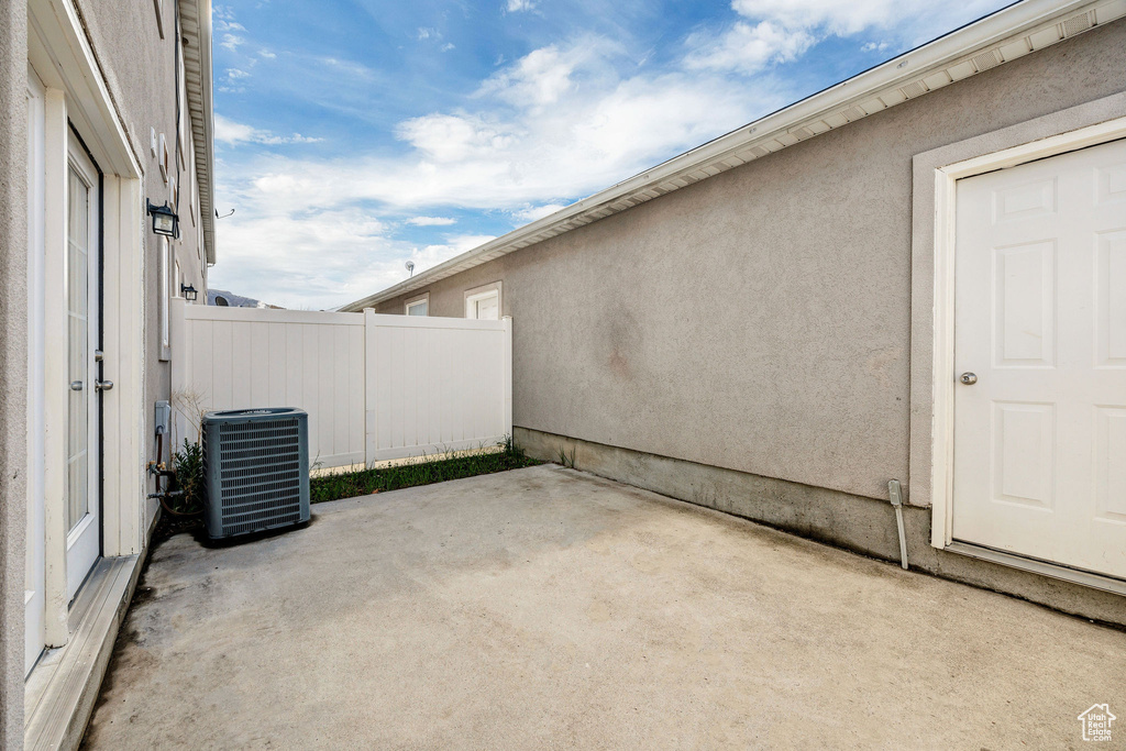 View of patio / terrace featuring central air condition unit and fence