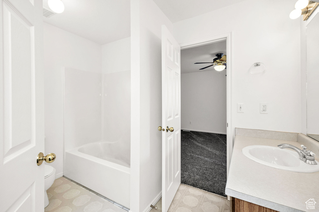 Bathroom featuring vanity, ceiling fan, tile patterned floors, and toilet