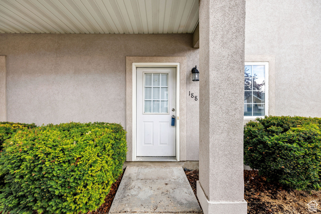 Property entrance featuring stucco siding