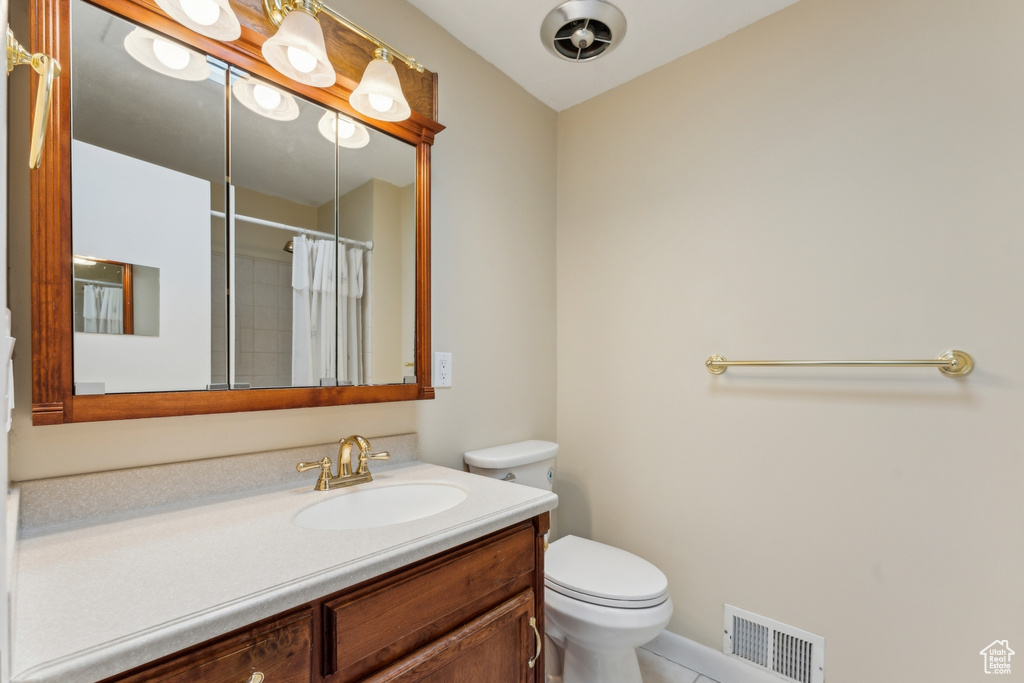 Full bath with tile patterned flooring, vanity, toilet, a shower with shower curtain, and visible vents