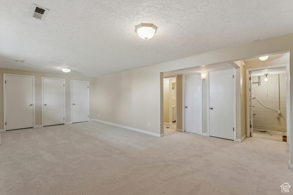 Unfurnished bedroom with multiple closets, baseboards, visible vents, and connected bathroom