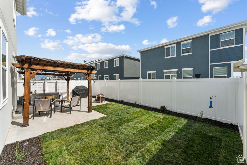 View of yard with an outdoor living space, a fenced backyard, a patio area, and a pergola