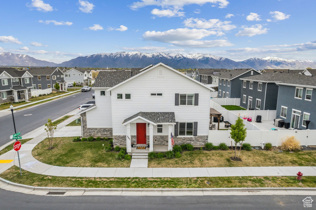 View of front of house featuring a mountain view, stone siding, and a residential view