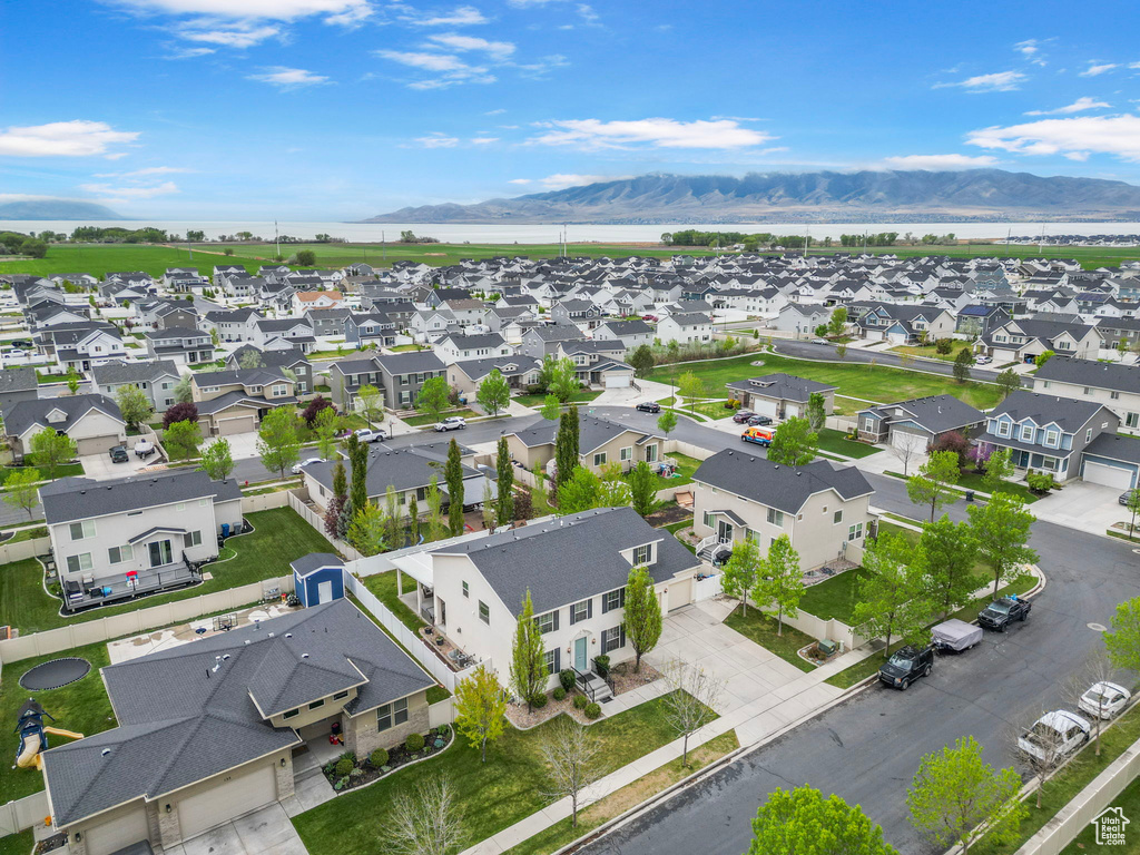Birds eye view of property featuring a water and mountain view and a residential view