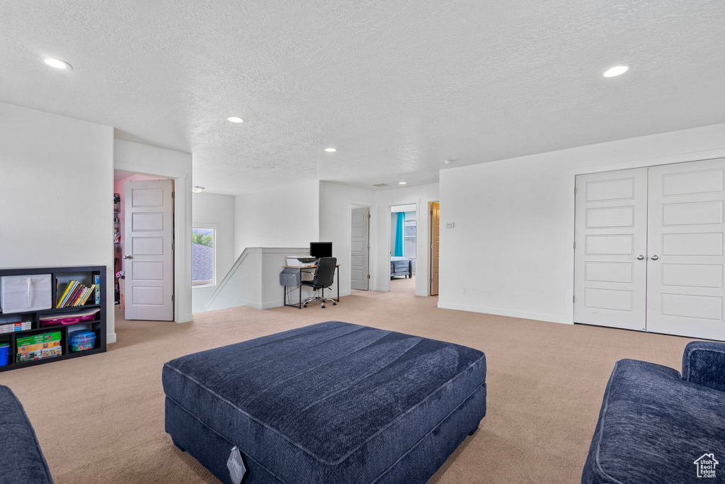 Carpeted bedroom featuring recessed lighting and a textured ceiling
