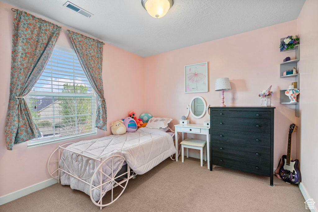 Bedroom featuring carpet floors, baseboards, and visible vents