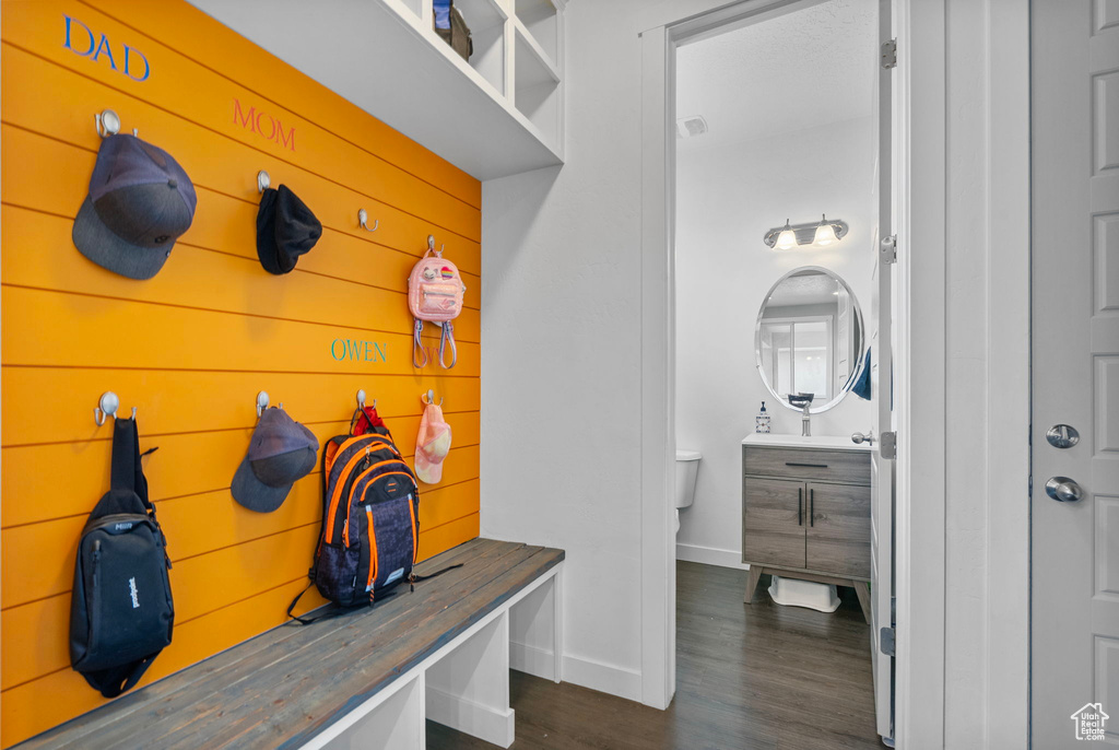 Mudroom featuring baseboards and dark wood-style flooring