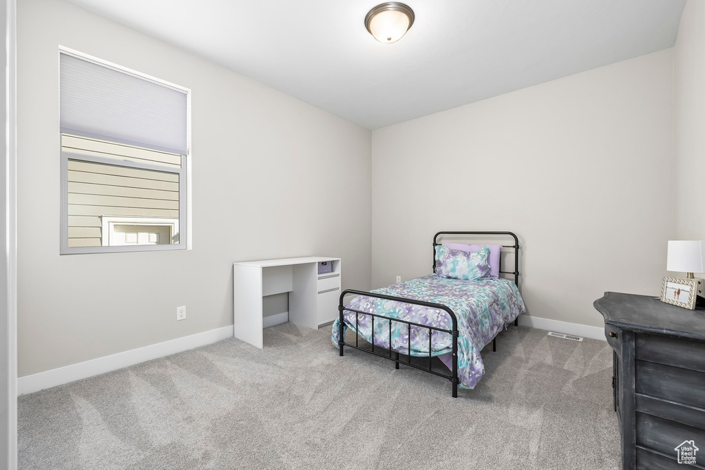 Bedroom with baseboards and carpet flooring