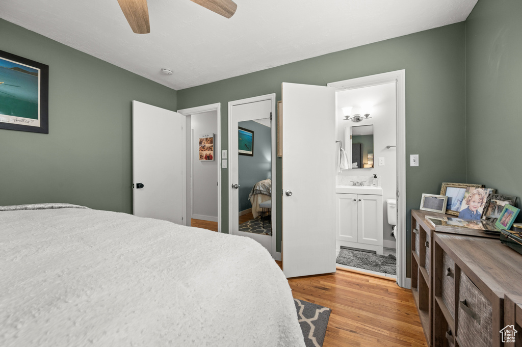 Bedroom featuring connected bathroom, a ceiling fan, and light wood finished floors