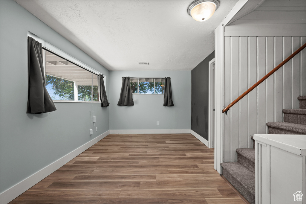 Stairs with baseboards and wood finished floors
