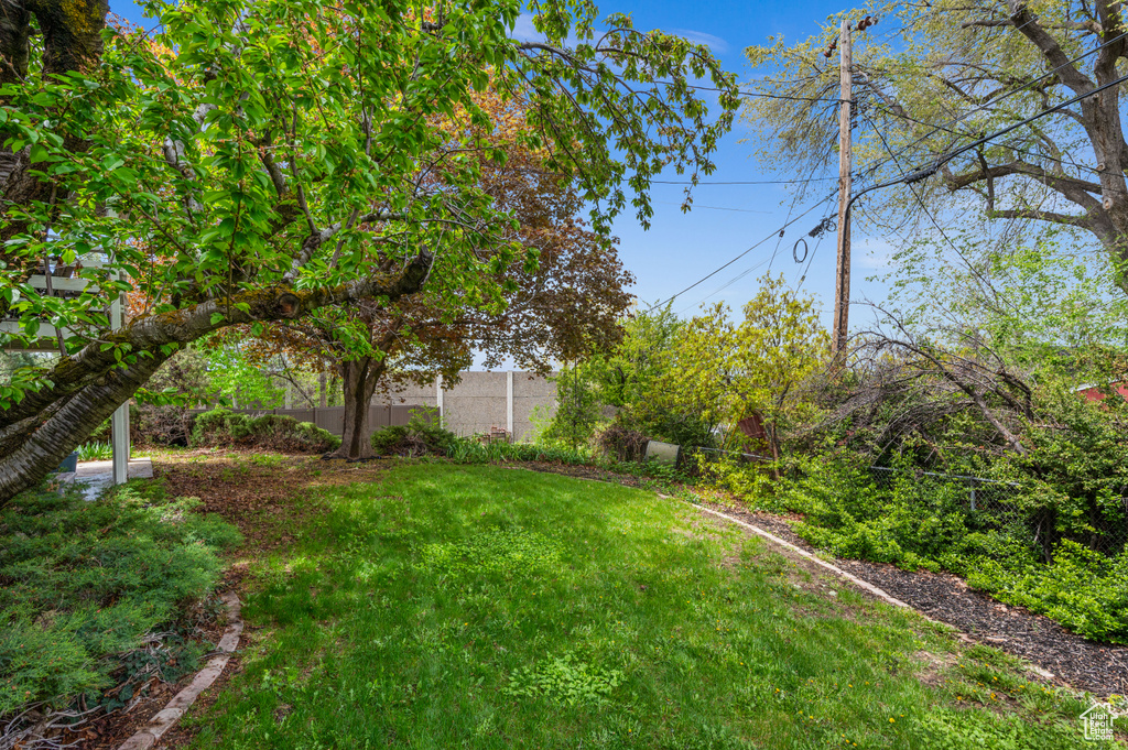 View of yard featuring fence