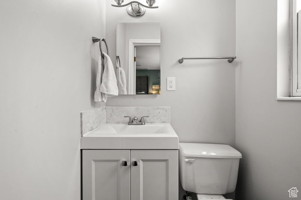 Half bathroom with vanity and toilet