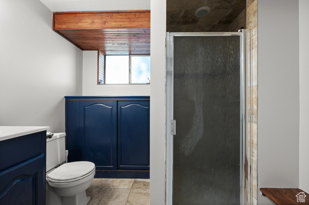 Full bathroom with a shower stall, vanity, and toilet