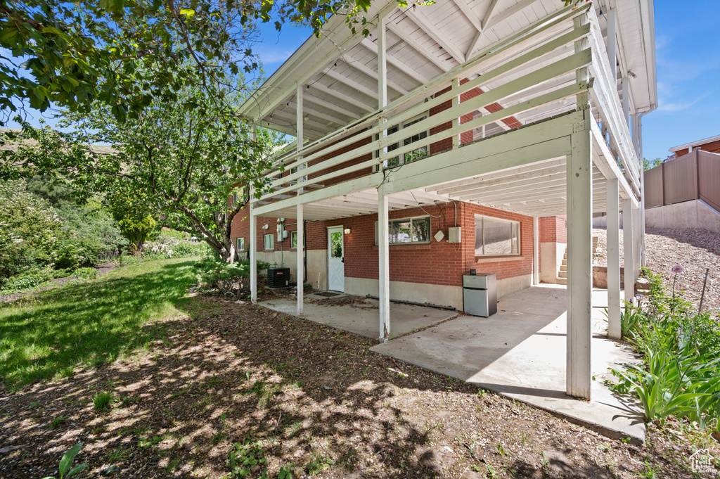 View of patio featuring a deck and cooling unit