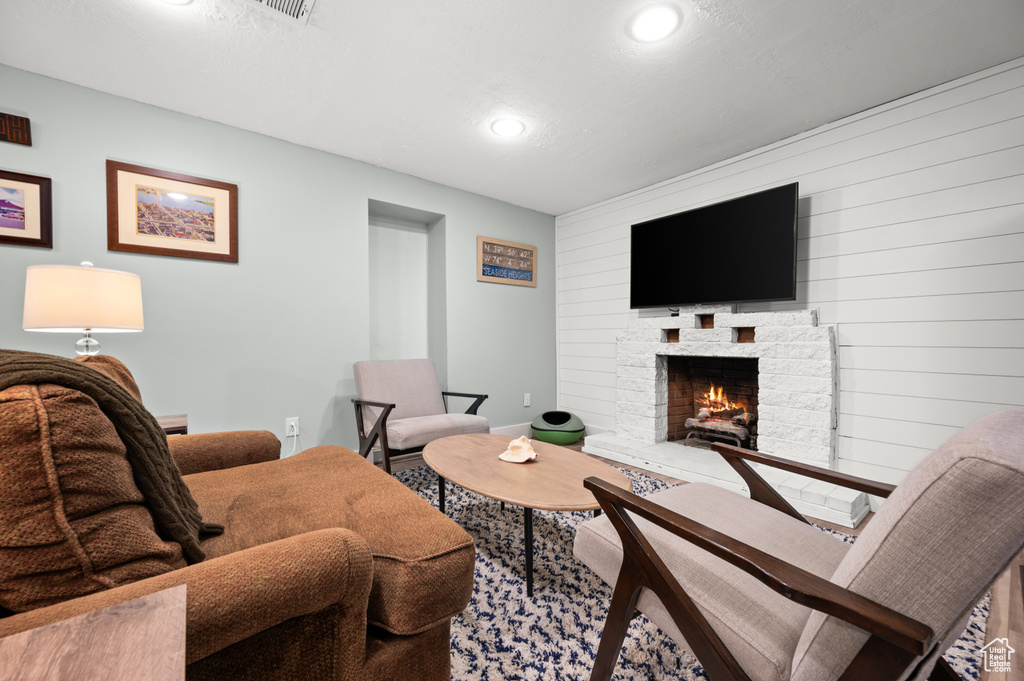 Living room featuring recessed lighting, baseboards, and a fireplace