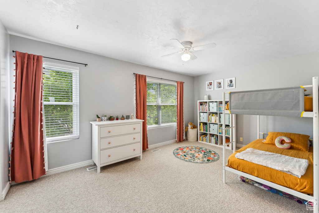 Bedroom featuring carpet floors, a ceiling fan, and baseboards