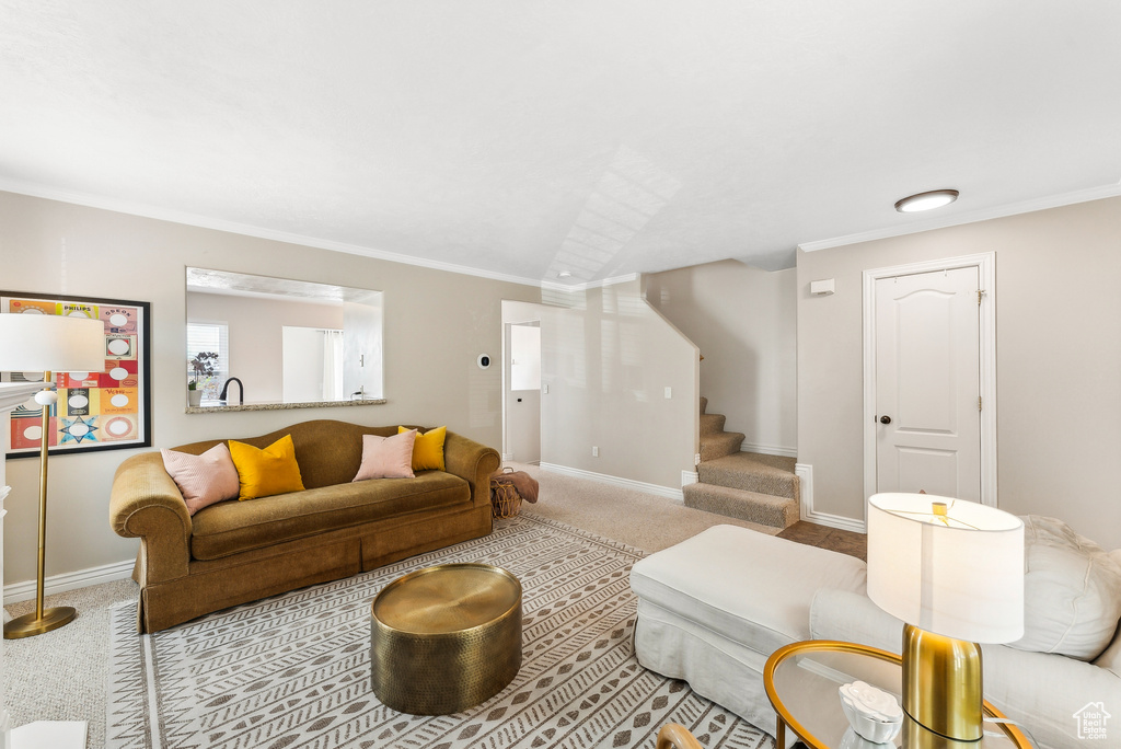 Living room featuring stairway, baseboards, crown molding, and carpet flooring