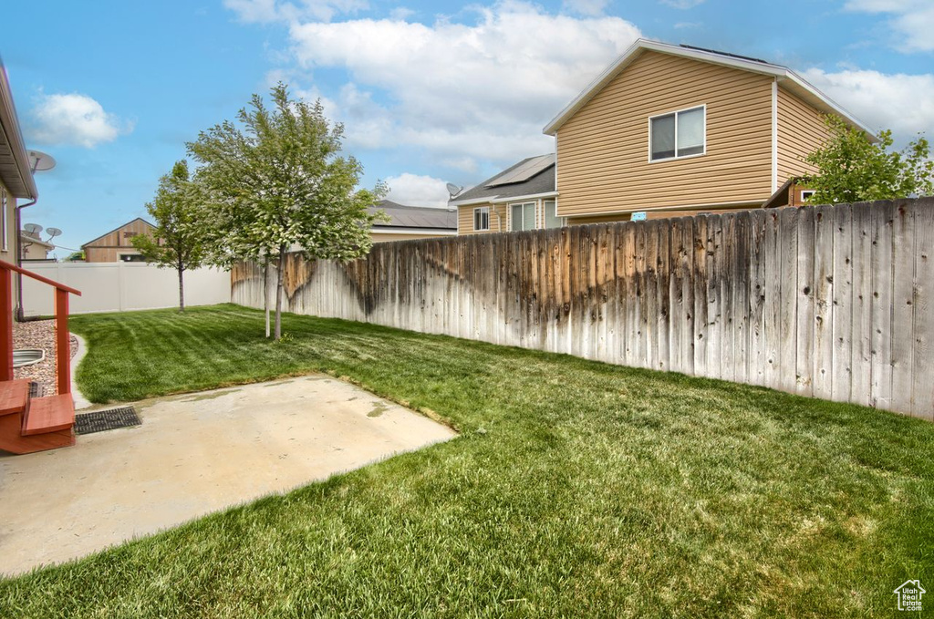 View of yard featuring a fenced backyard and a patio area