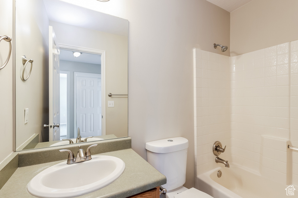 Full bathroom with toilet, tub / shower combination, and vanity
