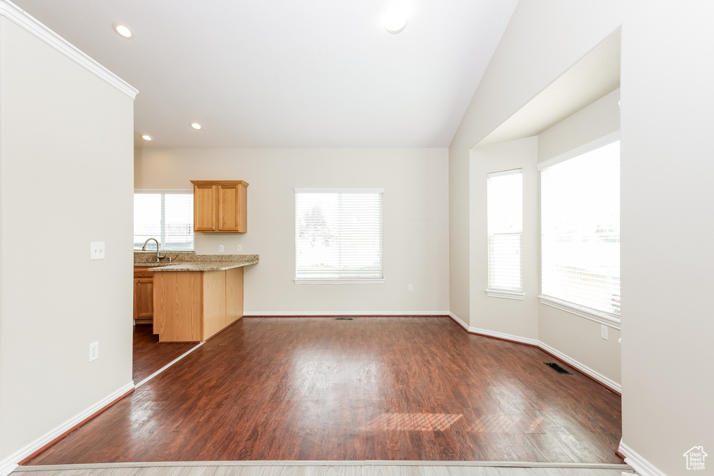 Unfurnished living room with dark wood finished floors, recessed lighting, a sink, baseboards, and visible vents