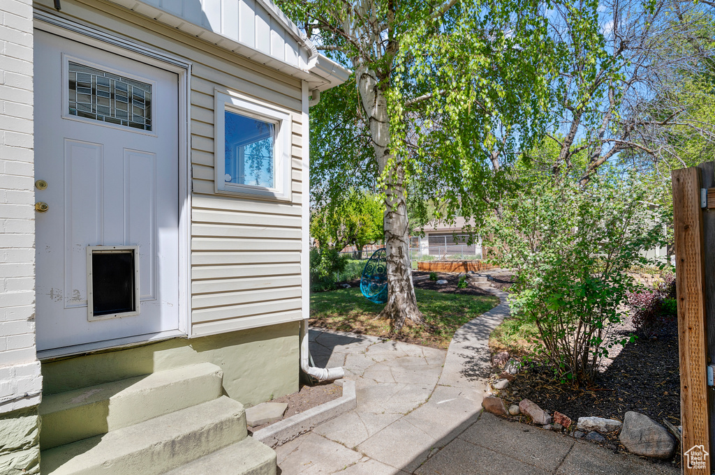 View of side of property with board and batten siding and entry steps