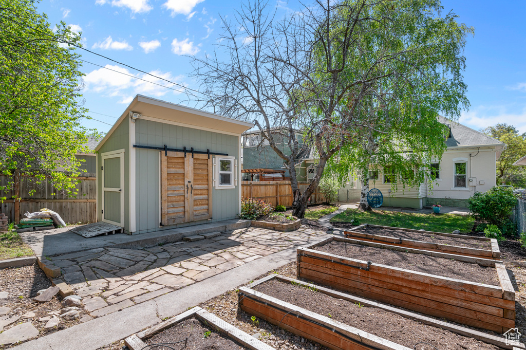 Exterior space featuring a garden and fence