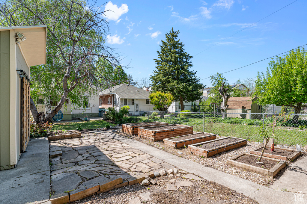 View of patio / terrace featuring fence and a vegetable garden