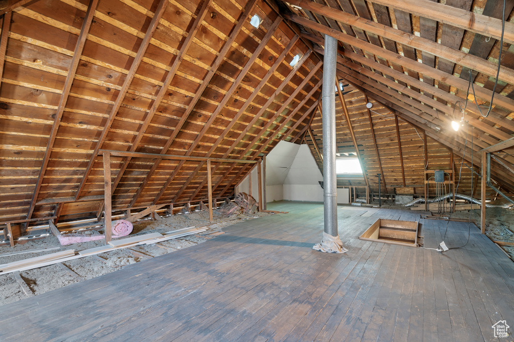 Unfinished attic with an upstairs landing