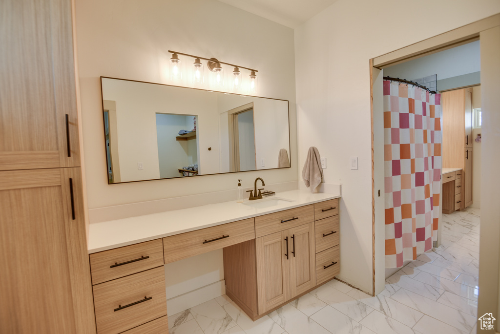 Full bathroom with vanity, a shower with curtain, and marble finish floor