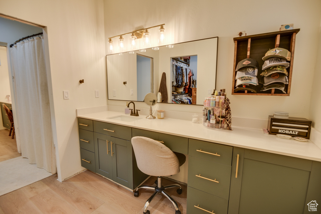 Full bathroom with vanity and wood finished floors