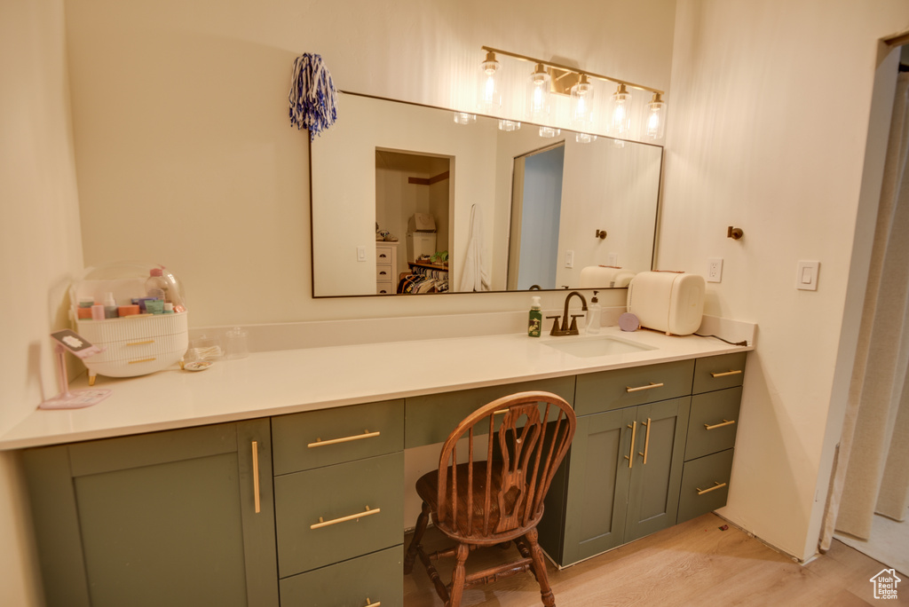 Bathroom featuring wood finished floors and vanity