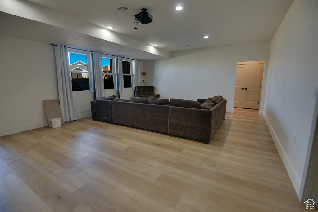 Living room featuring recessed lighting, baseboards, light wood finished floors, and visible vents