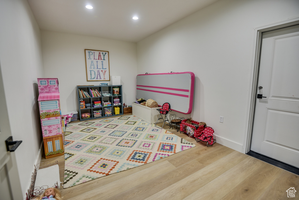 Game room with recessed lighting, baseboards, and wood finished floors