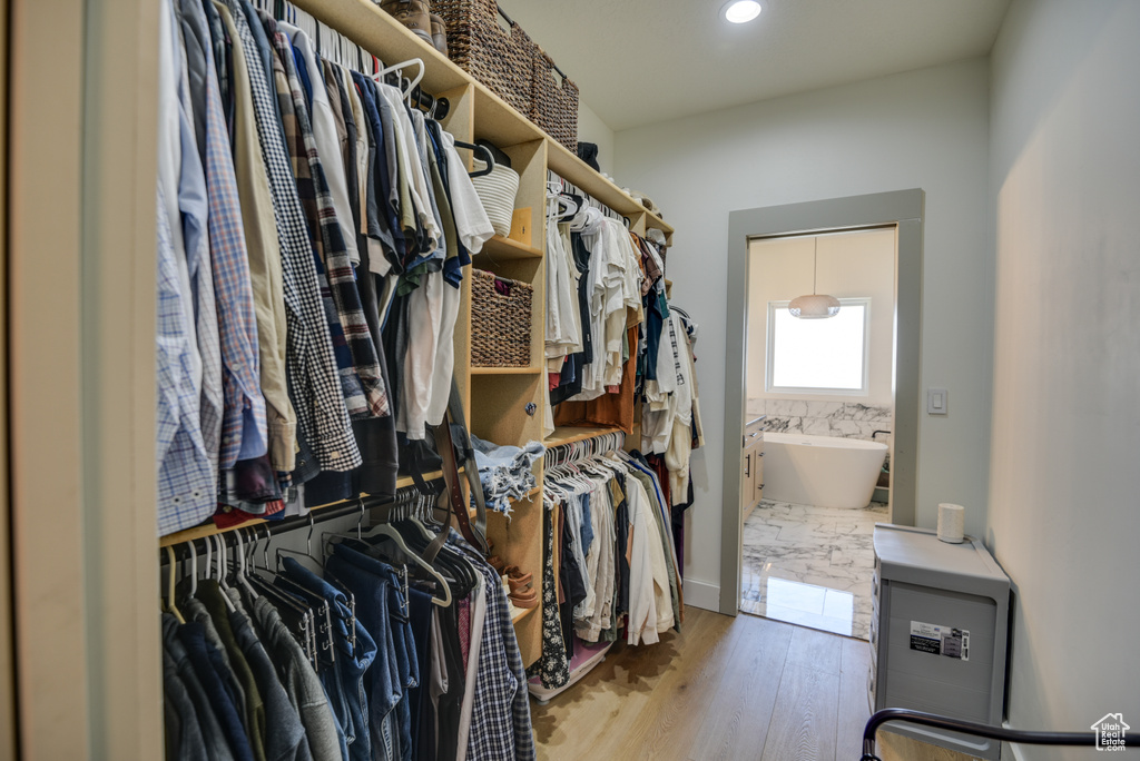 Spacious closet featuring wood finished floors