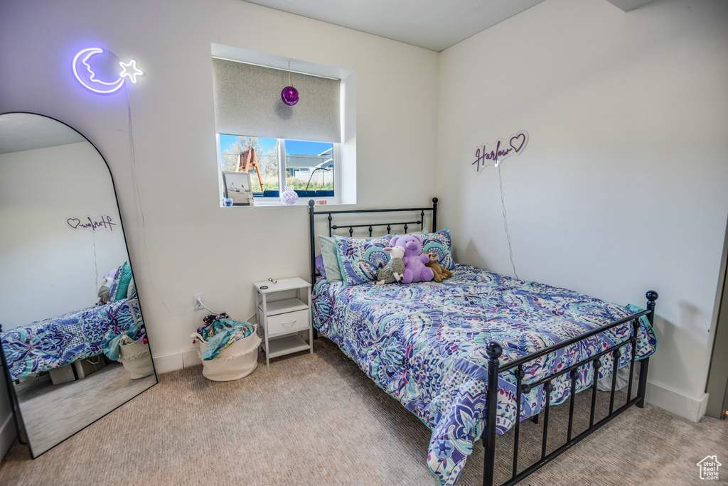 Bedroom with carpet floors and baseboards
