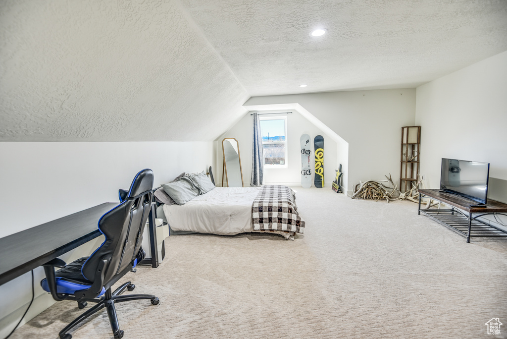 Carpeted bedroom with recessed lighting, a textured ceiling, and vaulted ceiling