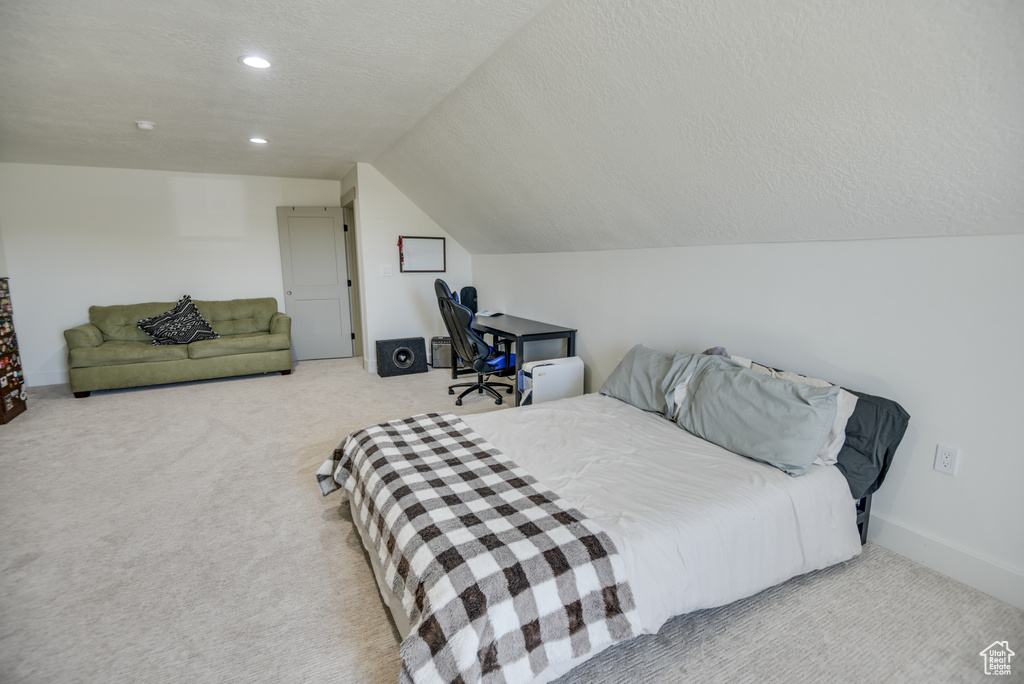 Carpeted bedroom with recessed lighting, a textured ceiling, and lofted ceiling
