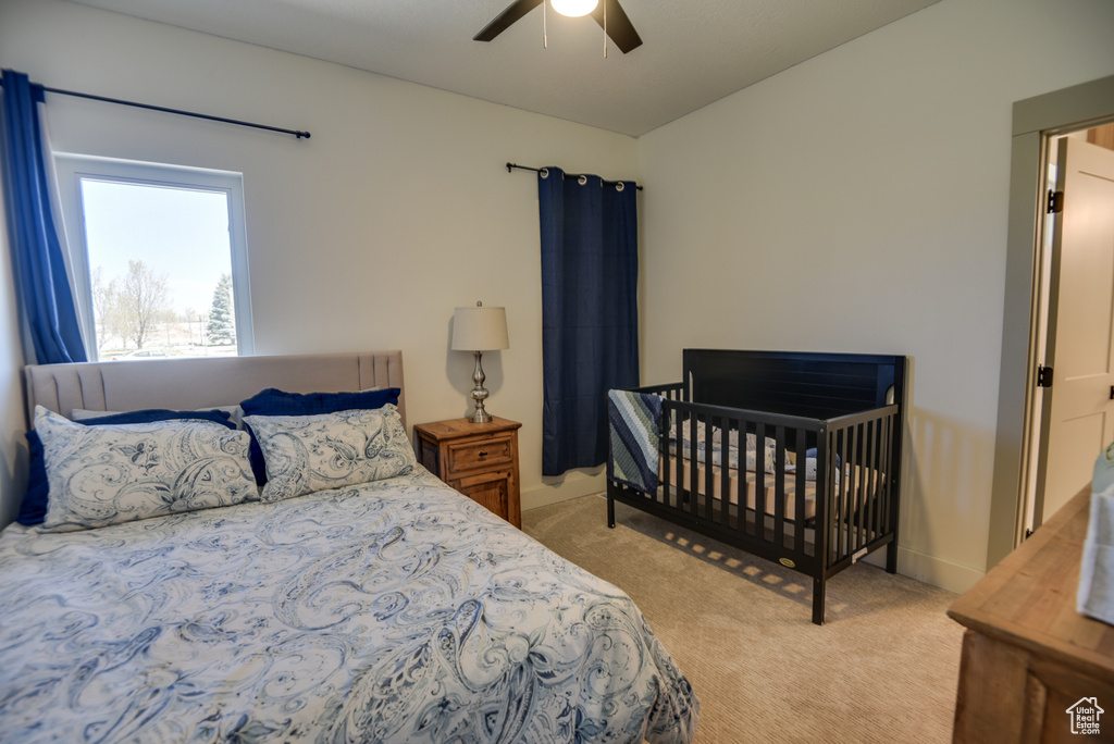 Bedroom featuring ceiling fan and light carpet