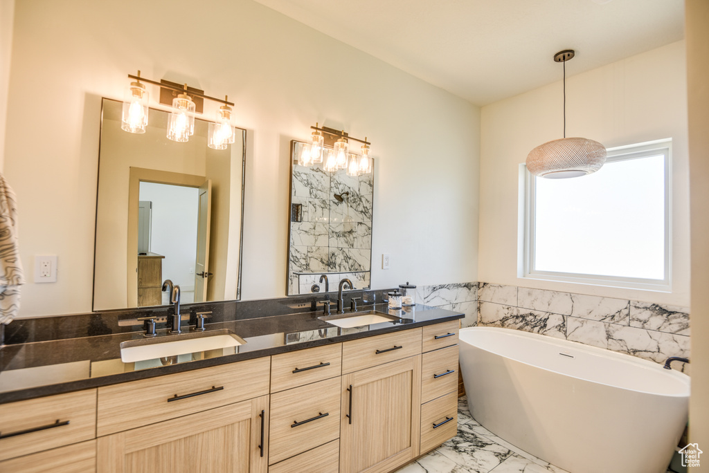 Full bathroom with double vanity, a sink, and marble finish floor