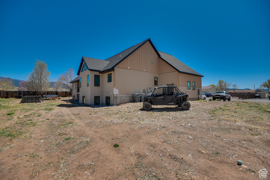Rear view of house featuring fence