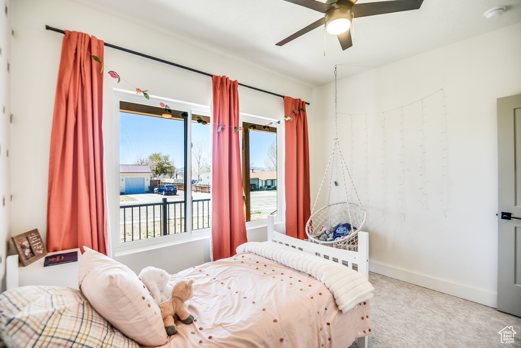 Bedroom with carpet floors, baseboards, and ceiling fan