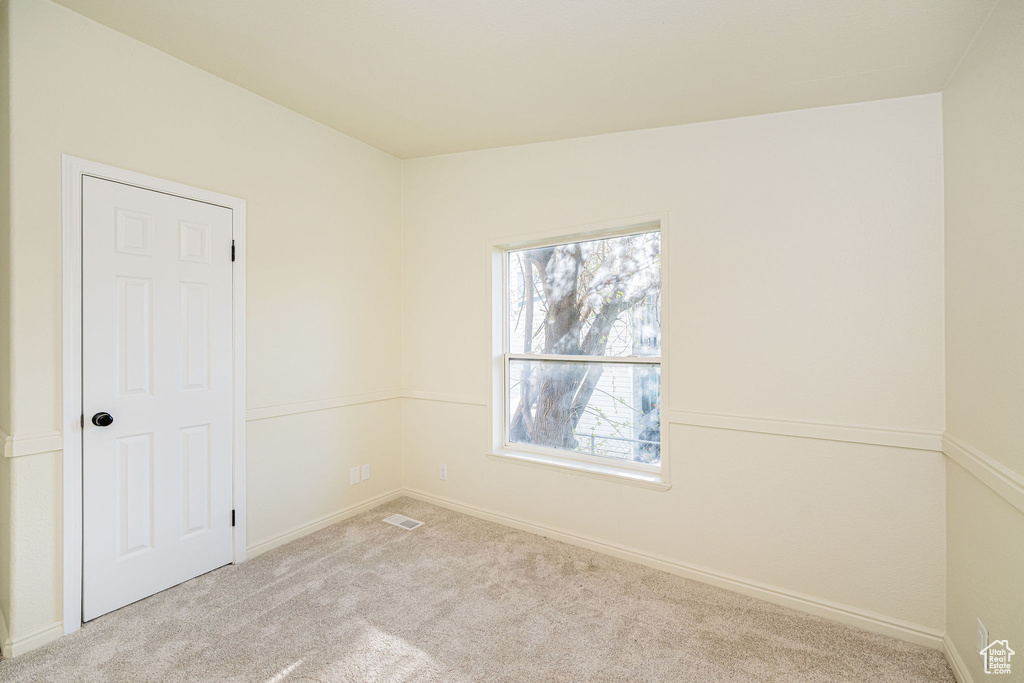 Empty room with baseboards and carpet