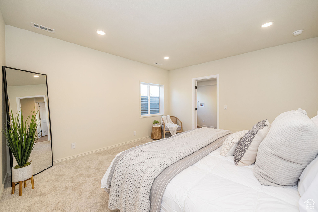 Bedroom with baseboards, visible vents, recessed lighting, and light colored carpet