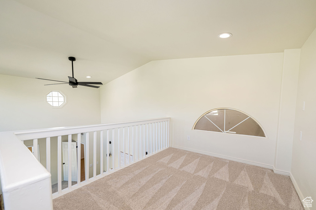 Interior space featuring a ceiling fan, baseboards, lofted ceiling, carpet, and recessed lighting