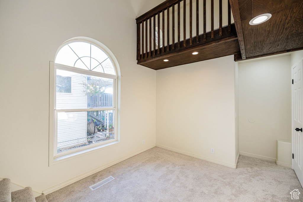 Unfurnished room featuring visible vents, stairs, carpet floors, baseboards, and recessed lighting